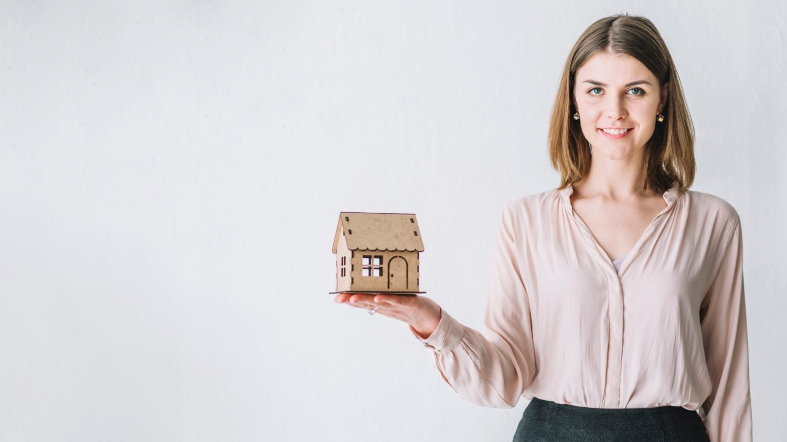 Woman-holding-toy-house